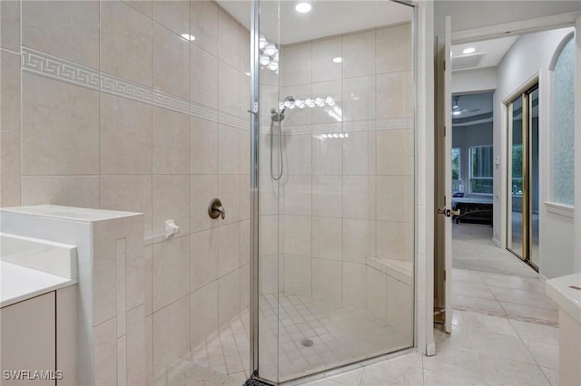 15120 Blackhawk Dr, Fort Myers, FL 33912 - ensuite bathroom with a shower stall, tile patterned flooring, vanity, recessed lighting, and tile walls