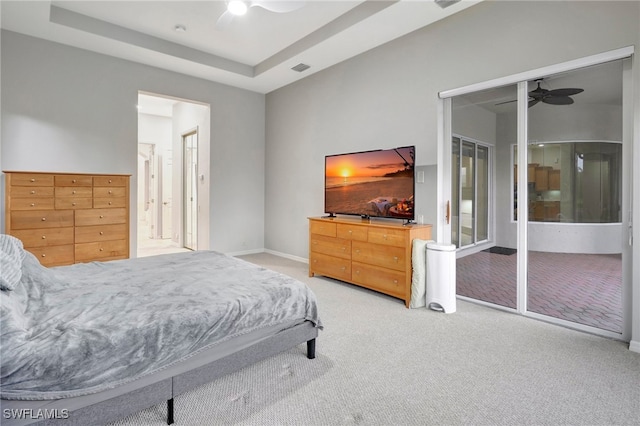 bedroom featuring a tray ceiling, ceiling fan, and carpet floors