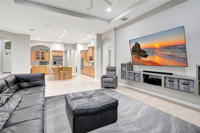 15120 Blackhawk Dr, Fort Myers, FL 33912 - living room with light tile patterned floors, arched walkways, a ceiling fan, and recessed lighting