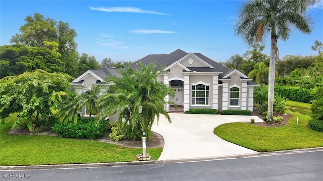 15120 Blackhawk Dr, Fort Myers, FL 33912 - view of front of home with curved driveway, a front yard, and stucco siding
