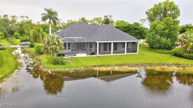 back of property featuring a water view, a lawn, and glass enclosure