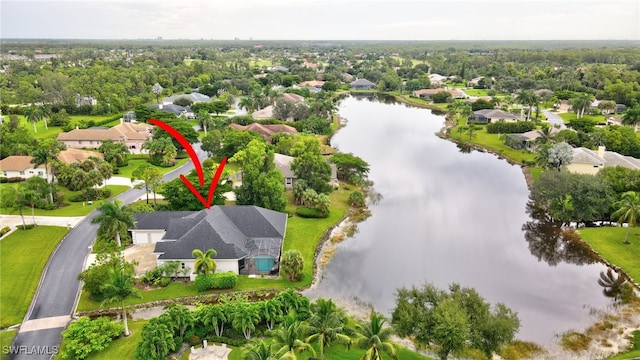 drone / aerial view featuring a residential view and a water view