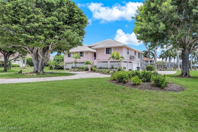 view of front of property with a front lawn and a garage