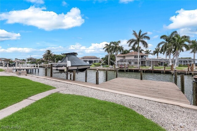 view of dock featuring a lawn and a water view