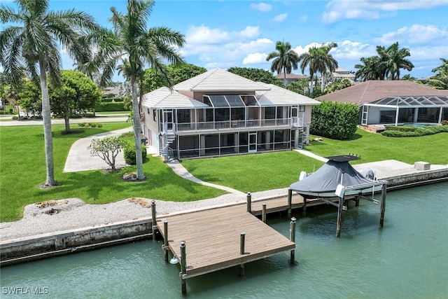 exterior space featuring a yard, a water view, and a sunroom