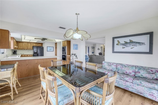 dining room with light hardwood / wood-style floors and sink