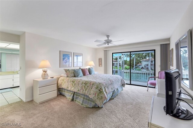 bedroom featuring multiple windows, light carpet, access to exterior, and ceiling fan