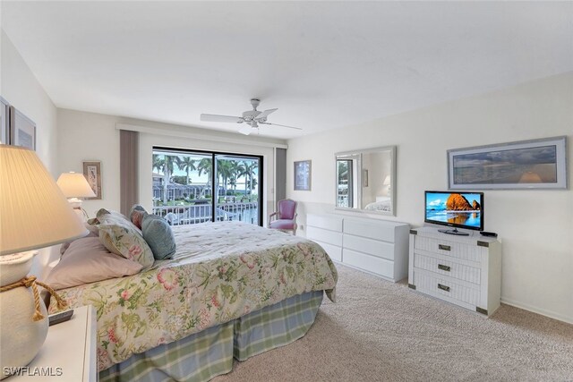 carpeted bedroom with ceiling fan and access to exterior