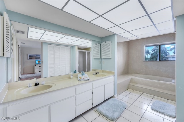 bathroom with plus walk in shower, vanity, and tile patterned flooring