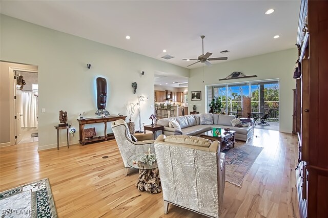 living room featuring light wood-type flooring and ceiling fan