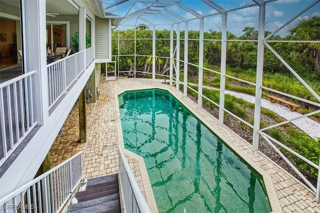 outdoor pool with a patio area and a lanai