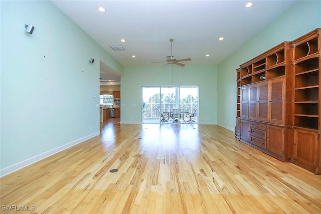 unfurnished living room featuring baseboards, light wood-type flooring, visible vents, and recessed lighting