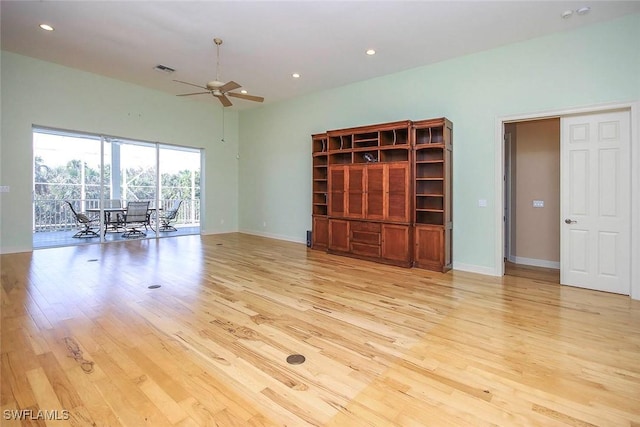 unfurnished living room with light wood-style floors, visible vents, baseboards, and a ceiling fan