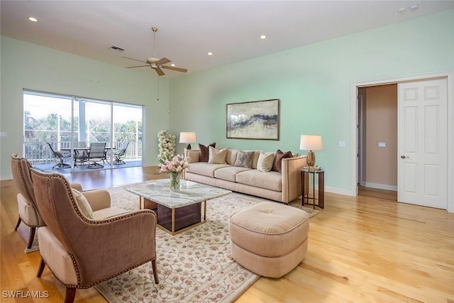 living area with light wood-style flooring, visible vents, baseboards, and recessed lighting