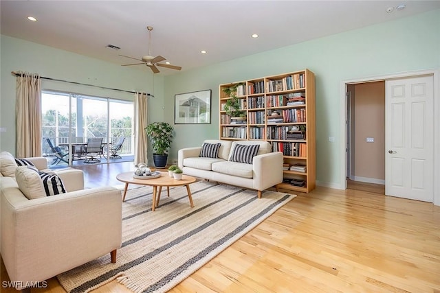 living room with recessed lighting, a ceiling fan, baseboards, visible vents, and light wood finished floors