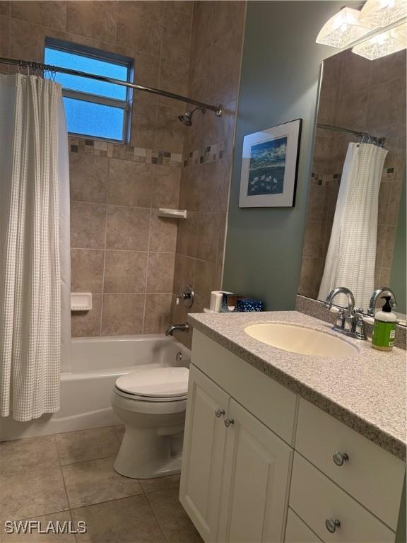 bathroom featuring shower / tub combo, vanity, toilet, and tile patterned floors