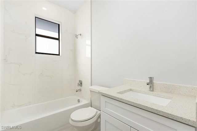 full bathroom featuring tiled shower / bath, vanity, and toilet