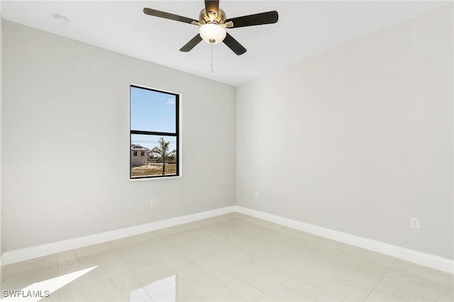 spare room with light tile patterned floors and ceiling fan