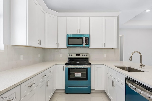 kitchen with sink, stainless steel appliances, decorative backsplash, and white cabinets