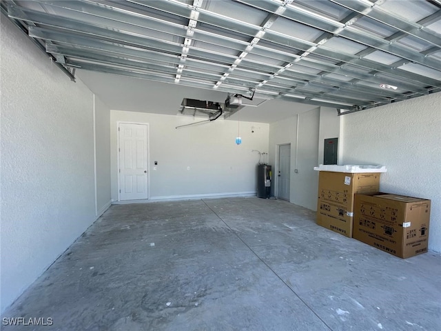 garage featuring electric water heater, a garage door opener, and electric panel