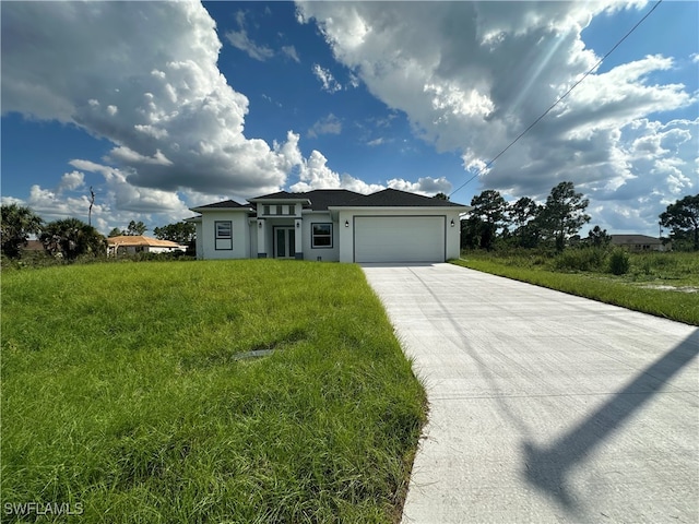 view of front of home featuring a front lawn and a garage