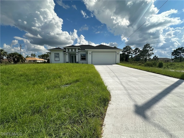 view of front facade with a front yard and a garage