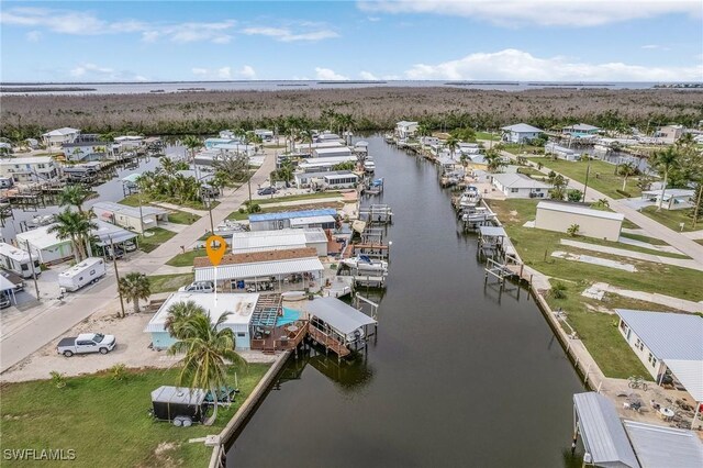 drone / aerial view with a water view and a residential view