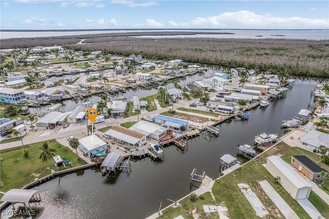 drone / aerial view featuring a water view and a residential view