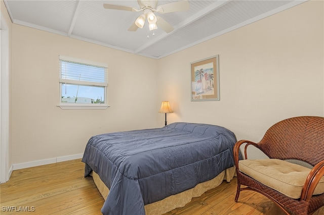 bedroom with light wood finished floors, ceiling fan, and baseboards