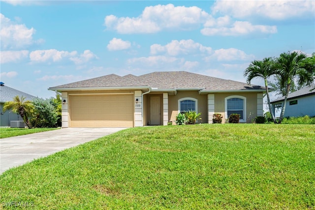 view of front of home with central air condition unit, a garage, and a front lawn