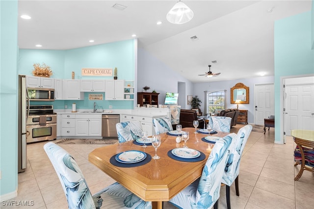 tiled dining room featuring sink, high vaulted ceiling, and ceiling fan