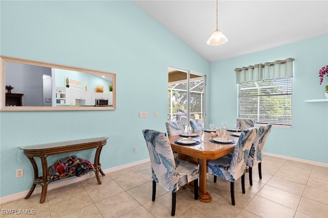 tiled dining area featuring a wealth of natural light and vaulted ceiling