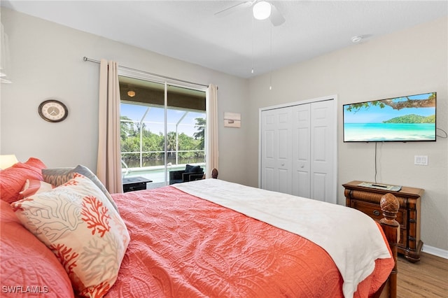 bedroom with ceiling fan, a closet, access to outside, and hardwood / wood-style floors