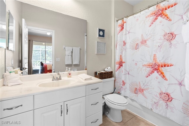 full bathroom featuring tile patterned floors, toilet, shower / bathtub combination with curtain, and vanity