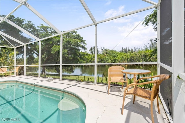 view of pool featuring a patio, a water view, and a lanai