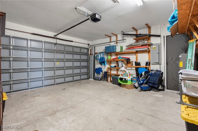 garage with a garage door opener and electric panel