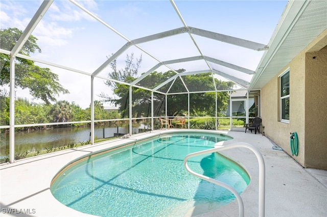 view of swimming pool featuring a patio and a lanai