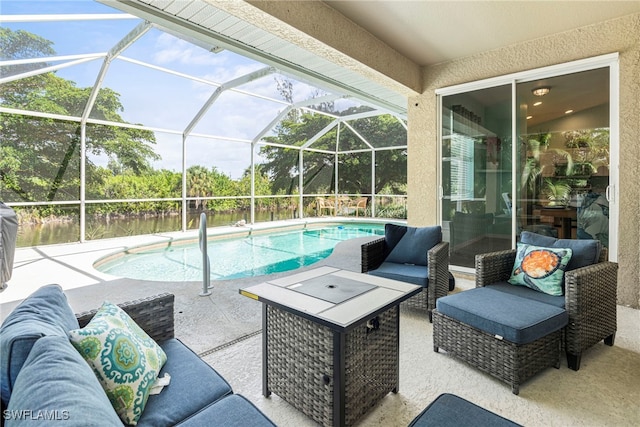 view of pool with an outdoor hangout area, glass enclosure, and a patio area