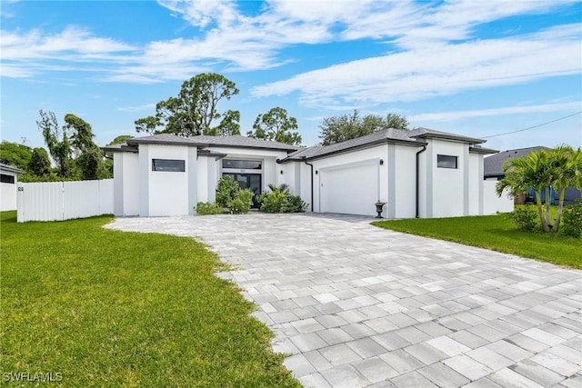 garage with fence and decorative driveway