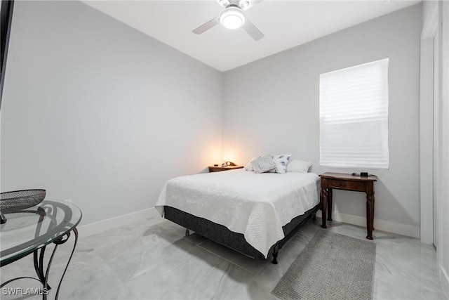 bedroom with a ceiling fan and baseboards