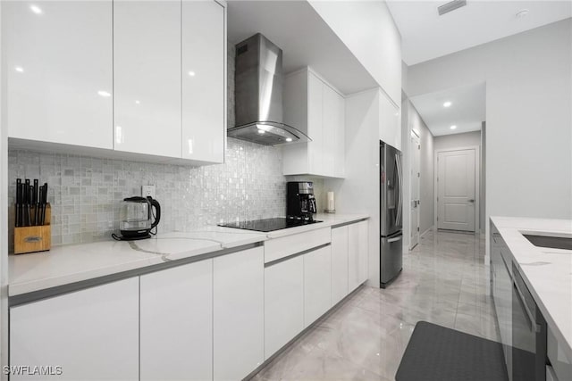 kitchen featuring wall chimney range hood, modern cabinets, and appliances with stainless steel finishes