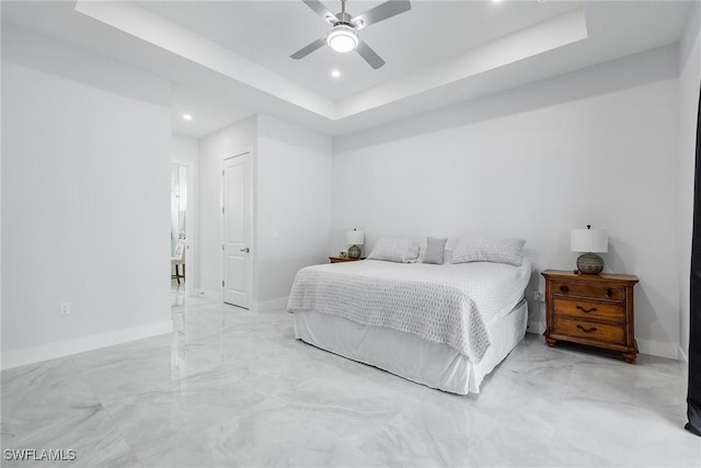 bedroom featuring a tray ceiling, recessed lighting, a ceiling fan, and baseboards