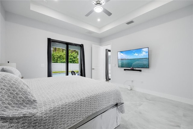 bedroom with ceiling fan, recessed lighting, visible vents, baseboards, and a tray ceiling