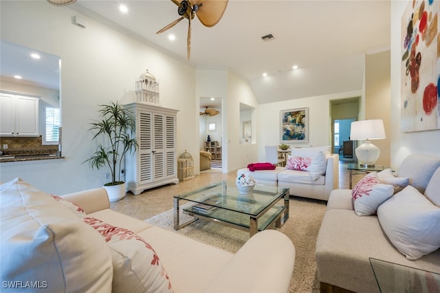 tiled living room featuring ceiling fan, vaulted ceiling, and ornamental molding