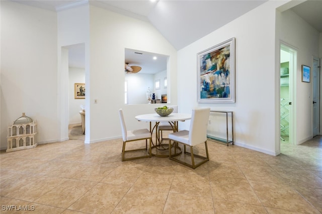 dining area featuring light tile patterned floors and lofted ceiling