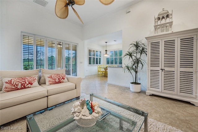 tiled living room with ceiling fan