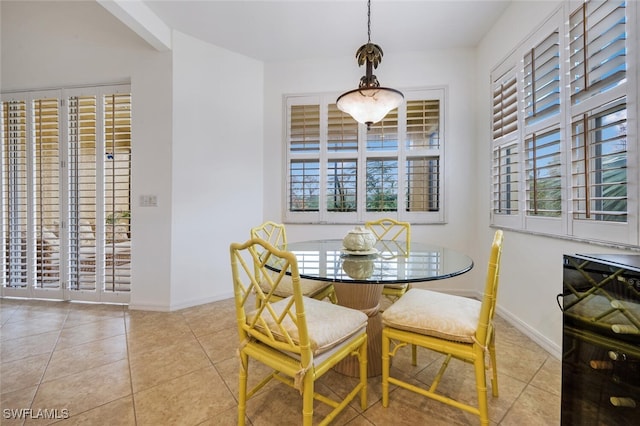 tiled dining area featuring a healthy amount of sunlight