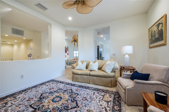 carpeted living room featuring ceiling fan