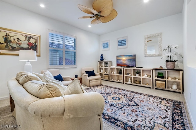 carpeted living room featuring ceiling fan