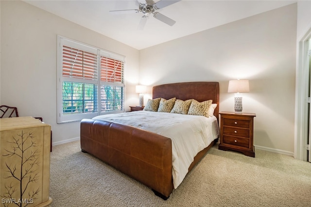 bedroom with ceiling fan and light colored carpet